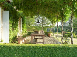 terras met stalen pergola en wisteria in de zomer frankrijk